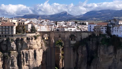 ronda village and new bridge on cliffside location. aerial reveal