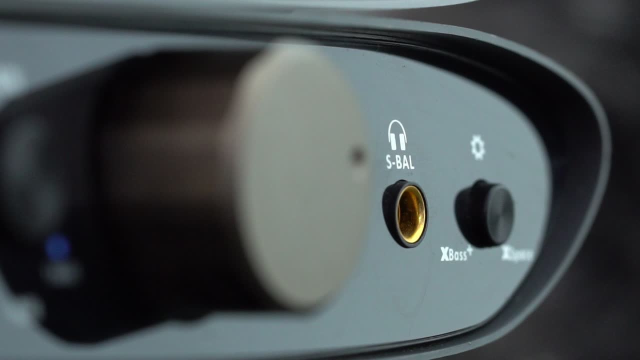 Close-up of a sleek audio interface with a focus on knobs and inputs