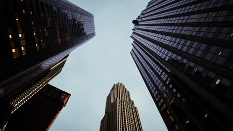 looking up at towering skyscrapers in an urban skyline during twilight hours