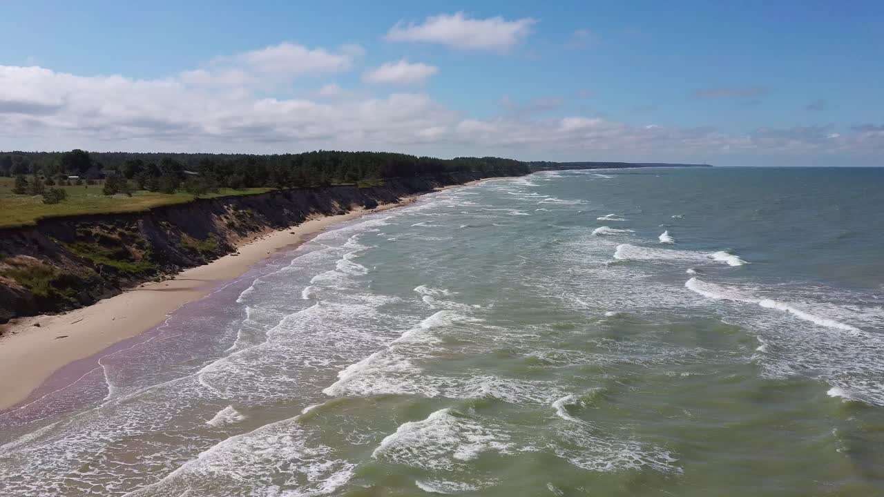 Flyvning over Østersøens kystlinje, Ulmale kystklipper nær Pavilosta, Letland, og jordskred med en tilgroet, bølgende klippe fyldt med huler og småsten
