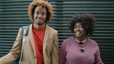 Portrait-of-Joyous-African-American-Friends-Outdoors-against-Black-Wall