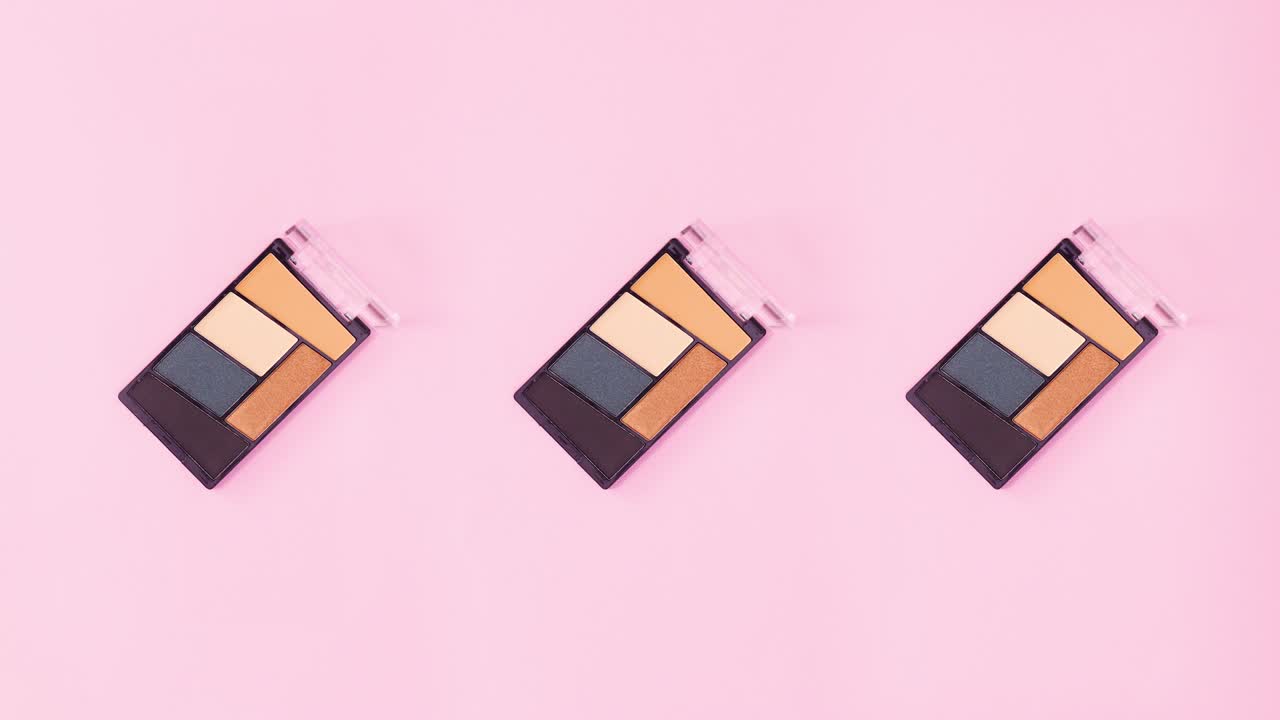 Eye shadows with various colors rotate on bright pink theme. Stop motion