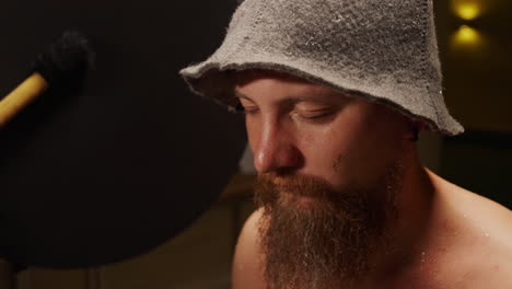 man with bucket hat in a studio setting
