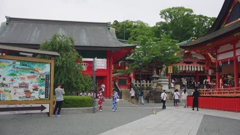 slow motion establishing shot of tourism at fushimi inari taisha shrine