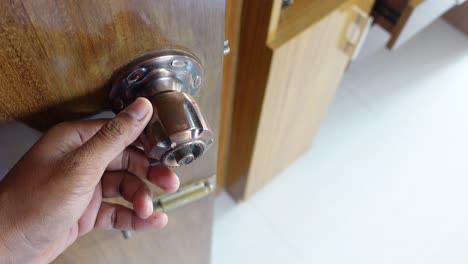 hand opening wooden door