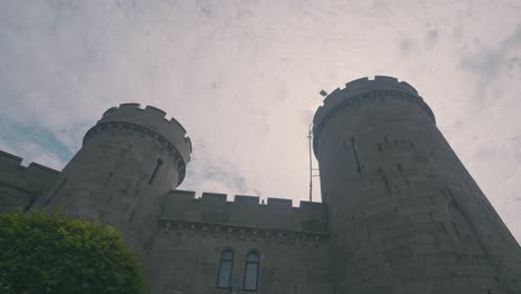 grey castle towers against cloudy sky