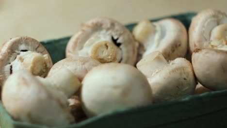 fresh button mushrooms in a box