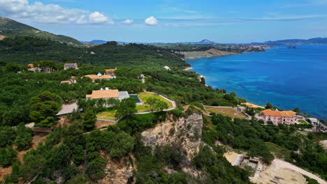 Luxury-villas-on-exotic-coastline-of-Greek-island,-aerial-view