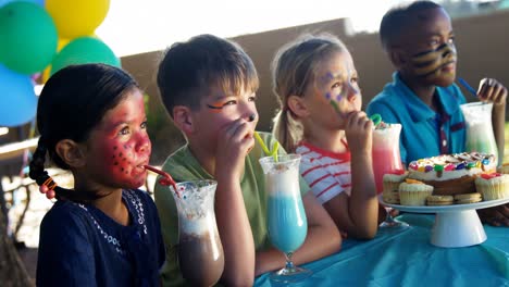 kids having sweet food and drinks in the playground 4k