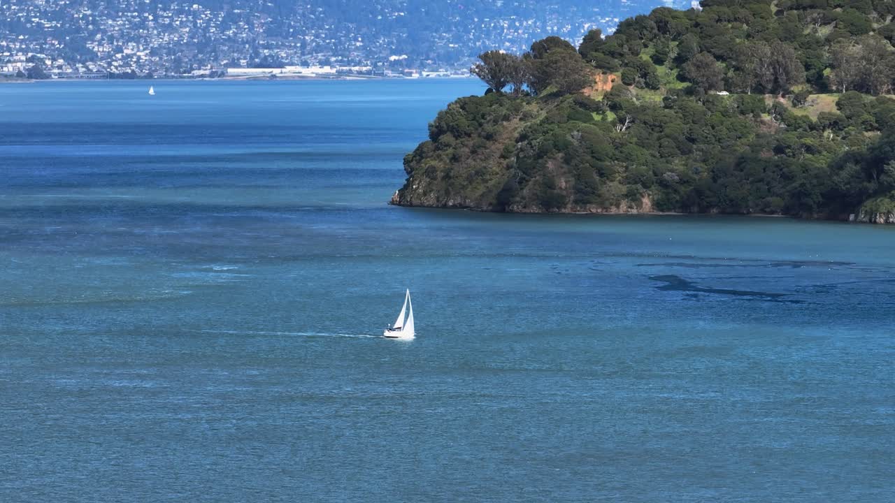 Telephoto drone shot of a sailboat on the bay of San Francisco, California, USA