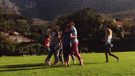 Students-messing-around-in-the-sprinklers-on-the-grass