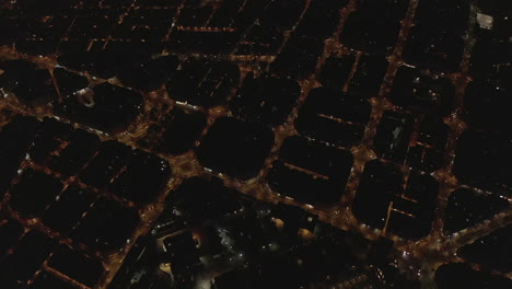 High-angle-view-of-large-city-at-night-with-illuminated-streets.-Revealing-complex-of-historical-Sant-Pau-hospital.-Barcelona,-Spain