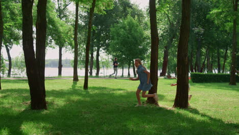 laughing children running on sunny meadow. happy kids play catch-up in park.