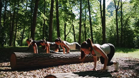 group of women exercising outdoors in a forest using a log