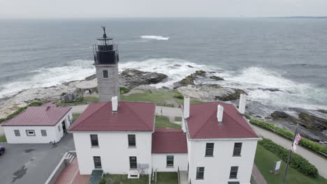 Aerial-pass-of-Beavertail-Lighthouse-in-Jamestown,-RI-looking-over-the-Atlantic-Ocean