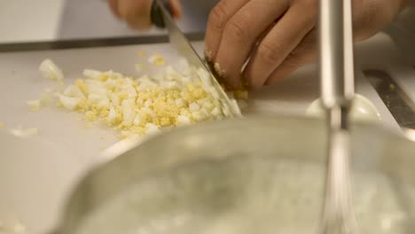 chef chopping hard-boiled eggs for egg salad