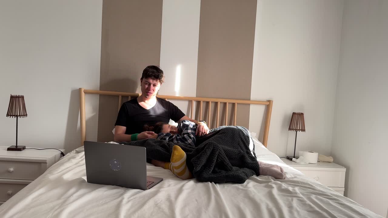 Couple and Child Relaxing on Bed