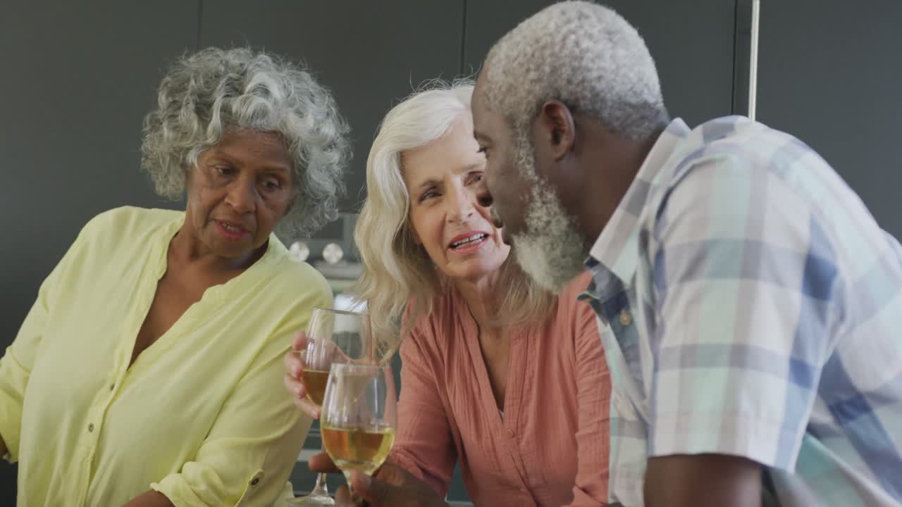 Happy senior diverse people cooking in kitchen at retirement home