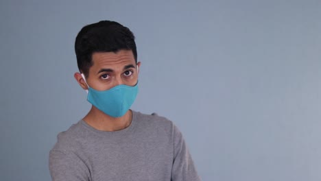 handsome hispanic model wearing a face mask at the covid pandemic