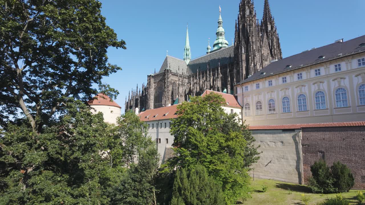 St. vitus cathedral in prague surrounded by lush greenery and historic buildings