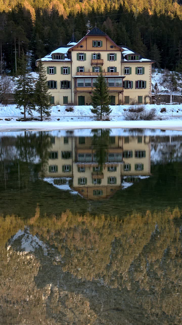 The Toblacher See lake in the municipality of Toblach in South Tyrol, Italy. Vertical