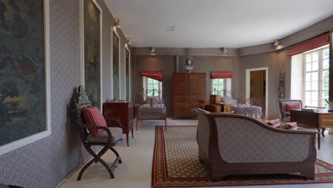 Slow-revealing-shot-of-a-double-bedroom-with-a-private-living-room-within-Chateau-de-Castille