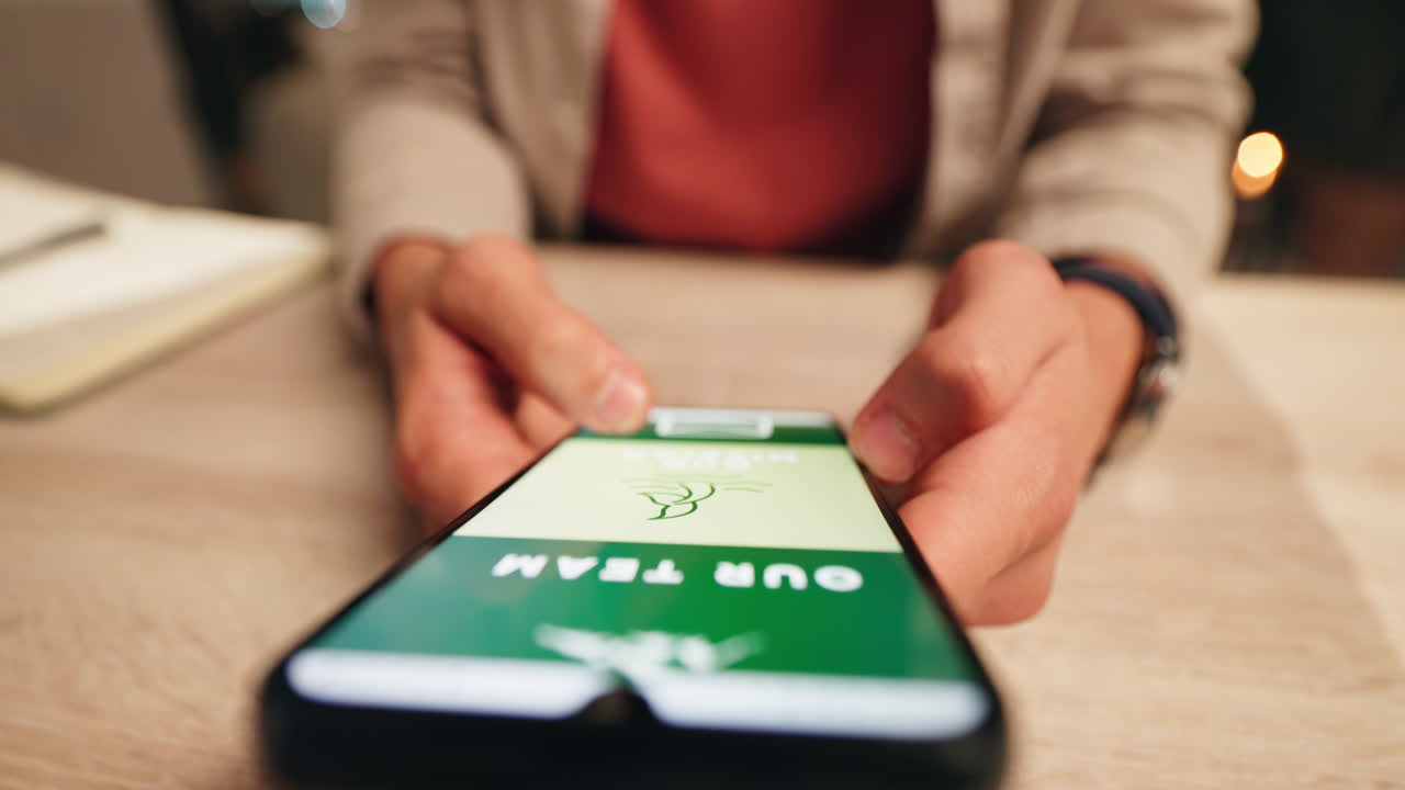 Person using smartphone with company website on screen