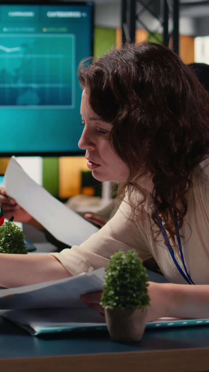 Vertical Video Professional group of female associates analyzing project documents
