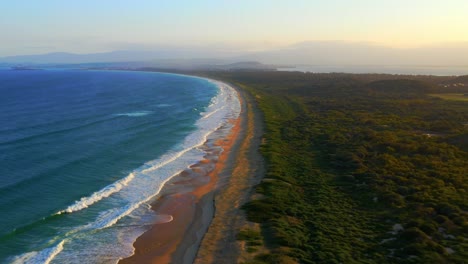 fast-moving aerial view of scenic wild natural beach - port kembla near wollongong, nsw australia