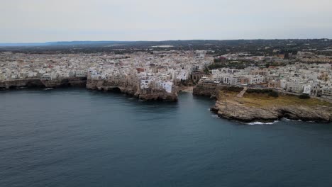 super wide aerial drone shot of polignano a mare, italy from adriatic sea