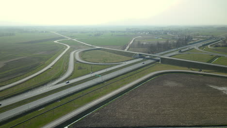 aerial view, the drone flies along parallel highway roads s7 cdry road and infinity road interchange in poland