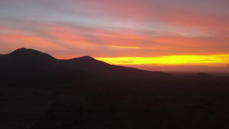 colorful sky dark sunset aerial, jungle mountain flight at dusk