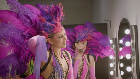 showgirls getting ready and applying makeup