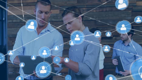 collaborating in modern office, two men with digital network animation overlay