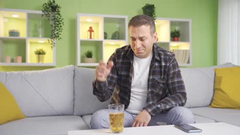 affected man drinks alcohol and talks to himself.