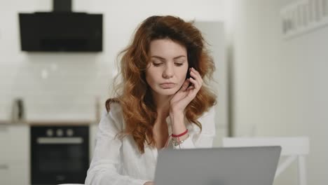 white woman working notebook at home. shocked lady reading information on laptop