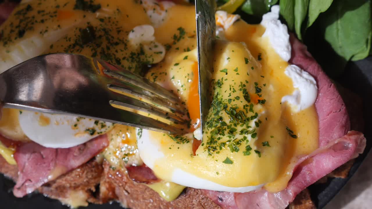 Close-up of Eggs Benedict being cut