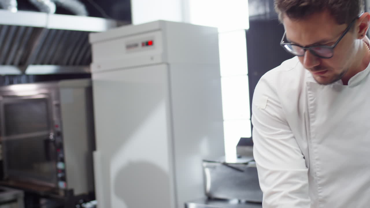Chef Preparing Order in Restaurant Kitchen