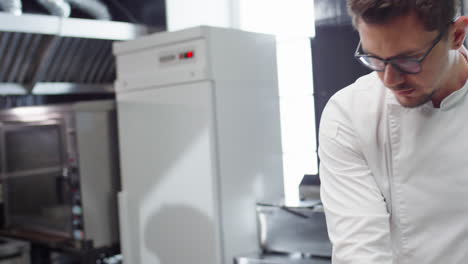 chef preparing order in restaurant kitchen