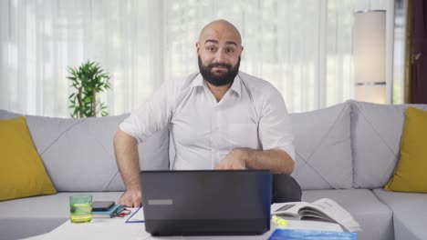 Home-office-worker-man-talking-facetime-looking-at-camera.