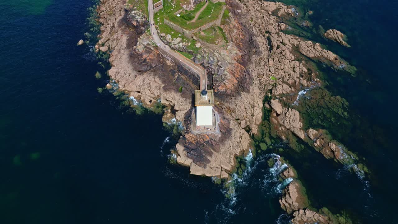 Upward panorama drone movement over the Strong and flagship of Kermorvan rocky coastline with lighthouse, Le Conquet, Brittany, France. Top shot