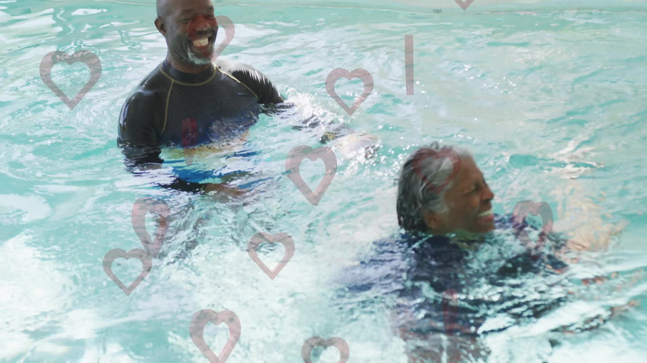 Two people enjoying swimming in pool with heart shapes overlay animation