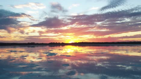 the sun sets on pink lake in esperance, australia