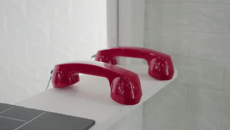 Sleek-retro-red-telephone-receivers,-a-callback-to-classic-communication-design