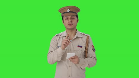 Serious-Indian-police-officer-writing-notes-about-the-case-Green-screen