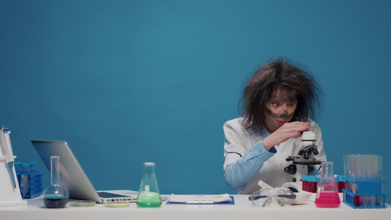 Insane foolish female chemist working with microscope in studio