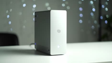 a sleek, modern tech device showcased in a blurry background of sparkling lights, capturing the essence of minimalist design and contemporary aesthetics