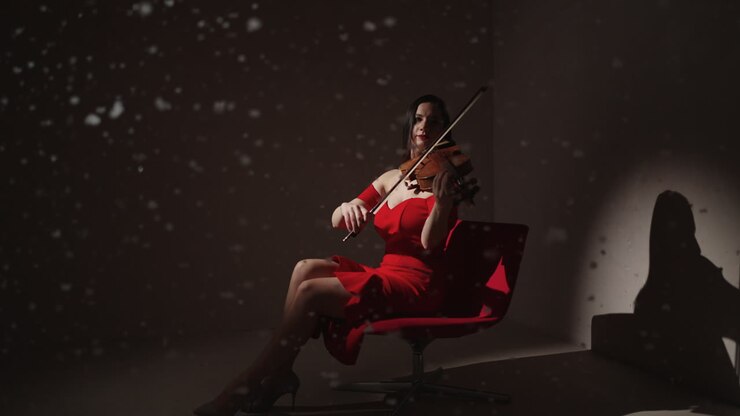 Woman Playing Violin in Red Dress