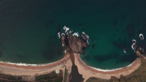 Aerial-Drone-Top-Down-White-Sand-Bay-Rock-Cliff-at-Kyotango-Japan-Sea-Beach,-Japanese-natural-summer-environment,-clean-blue-water,-geological-formation