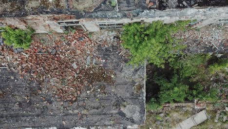 ruins of abandoned old broken industrial factory or warehouse buildings after disaster, war or cataclysm